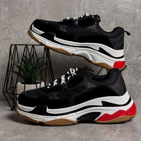 Black high-top sneakers in the Triple S style