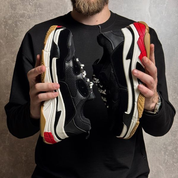 Black high-top sneakers in the Triple S style
